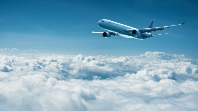 Airplane flies above clouds air travel