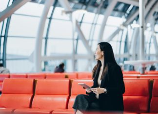 The 5 issues you may get at no cost at airports smiling young asian woman reading 763086270