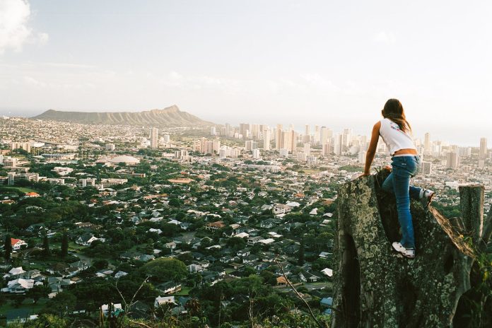 Preteen overlooking Honolulu cityscape Blasius Erlinger