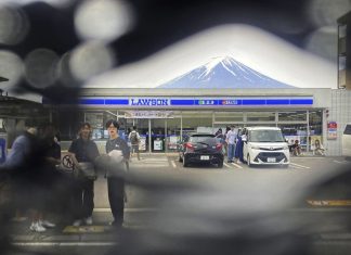 The screen set up to block tourist snapshots of Mount Fuji has several holes